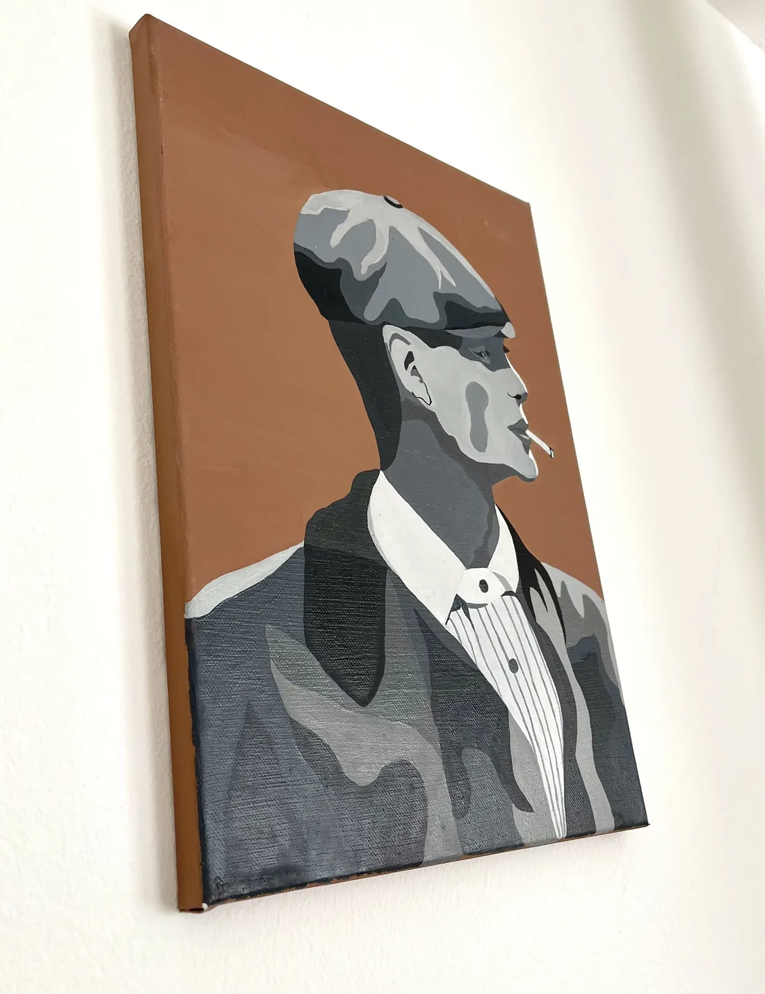 “Old Fashion” on a white wall, seen at an angle so the canvas edge and its shadow show.